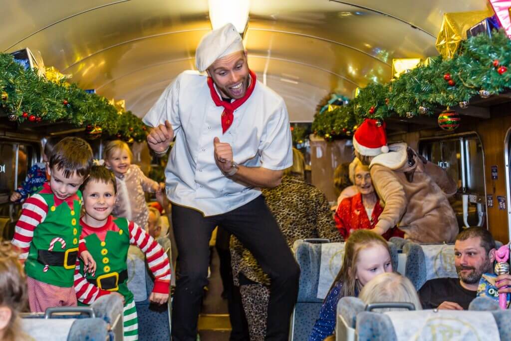 Chef dancing on on board THE POLAR EXPRESS™ in the UK Wensleydale 